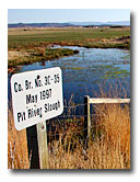 A sign identifies this section of the Pit River as the Pit River Slough.